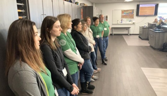 VALU class members lined up against the cabinets in the animal health program as they listen to instructor Mike Seibert. 