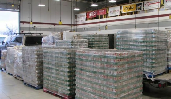 Pallets of canned goods wrapped in plastic that are ready to be taken to local food pantries. 
