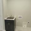 Laundry room with closet and sink just inside the entrance from the garage.  Also includes a half-bath.: Gallery Image 2 