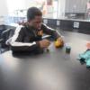 A visiting sophomore is trying his hand at injecting an orange in Animal Health as a Tri Star senior monitors his work.: Gallery Image 1 