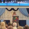 Mrs. Speck at the podium giving her thoughts on the seniors.: Gallery Image 1 