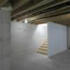 Basement with window and two sets of stairs from garage and house: Gallery Image 1 