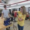 Celina 8th grader tries her hand at using an impact drill.: Gallery Image 1 