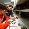 REC Tech senior works with a sophomore on a circuit.: Gallery Image 1 