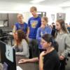 Eighth graders watch and listen as Interactive Media students talk about a program they use.: Gallery Image 2 