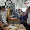 Precision Machining students show 8th graders what a blueprint is and explain how it is used.: Gallery Image 1 