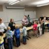 Teacher education students and elementary students participating in an activity together. 