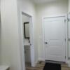 Entrance hall from garage includes half bath, hook nook, storage, and laundry room: Gallery Image 1 