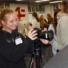 A visiting sophomore takes a photo in graphics.: Gallery Image 1 