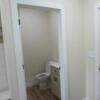 Entrance hall from garage includes half bath, hook nook, storage, and laundry room: Gallery Image 2 