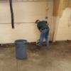 Teacher Brent Tippie sweeping up at the Dennings Building.: Gallery Image 1 