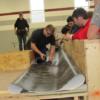Construction students learn and participate in a lesson in commercial roofing with a Cotterman representative. 