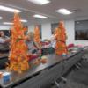 Several students are pictured at work on their twinkling fall topiary tree during a one-night workshop.: Gallery Image 1 