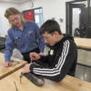 Senior helping a sophomore in Auto Tech.: Gallery Image 1 