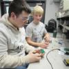 A Sophomore works on a circuit under the watchful eye of a REC Tech senior.: Gallery Image 2 