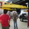 Inspecting the underside of a vehicle on the lift. 
