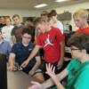 A willing eighth grader trys out an electronic game during the Engineering Technology tour.: Gallery Image 1 