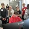 An Engineering student shows a group of eighth graders what he is drafting on the computer.: Gallery Image 1 
