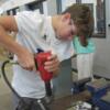 An 8th grade student tries using an impact drill in the Ag. Industrial Tech. lab.: Gallery Image 1 