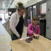 A mother and daughter select a metal laser cut bunny while in the welding room.: Gallery Image 1 