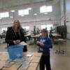 On the hunt, mother and son pick up a treasure (a hand made pocket maze) in the precision machining room: Gallery Image 1 