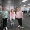 A grandmother and granddaughter and friend pose in the Teaching Professions room.: Gallery Image 1 