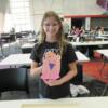 This student proudly shows off her completed chick.: Gallery Image 1 