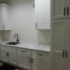Large laundry room with hook-up for washer and dryer, sink and laminate countertops, and tons of storage.: Gallery Image 1 