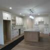 Kitchen with white painted cabnetry, wood stained island, and granite countertops.  Appliances not incuded.: Gallery Image 1 