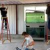 Junior Construction students mudding drywall in the animal barn.: Gallery Image 1 