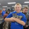 Student poses with the chinchilla in Animal Health. 