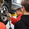 A Minster 8th grader screws on a lug nut in auto tech.: Gallery Image 1 