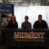 Midwest Plumbing & Heating representatives with the Tri Star student they employ.: Gallery Image 1 