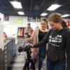 A New Knoxville 8th grader tries using a camera in graphic communications with the help of a graphics student.: Gallery Image 1 
