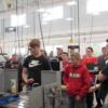 A Precision Machining student makes an adjustment as he talks to New Knoxville students about his program.: Gallery Image 1 