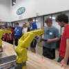 Visiting sophomores try their hand a on the FANAC robot teach pendants as seniors give help.: Gallery Image 1 