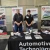 Tri Star auto tech instructor Brian Hess (lft) and Mason Link pose with banners at the SkillsUSA competition.: Gallery Image 1 