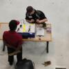 A birds eye view of Mason as he works on an electrical component during the SkillsUSA competition.: Gallery Image 1 