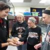 Minster eighth graders touch a lizard being held by an animal health student during 8th grade tours of the program. 