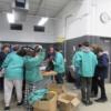 Visiting sophomores putting on welding leathers in the welding lab.: Gallery Image 1 