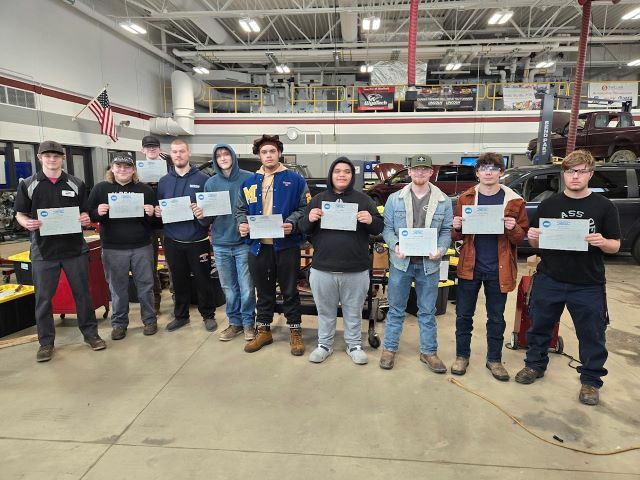 Senior Auto Tech students pose with their ASE certificates in the auto tech lab.: Featured Image 1 
