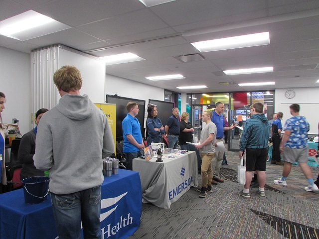 Students visit employer booths at the spring job fair.: Featured Image 1 