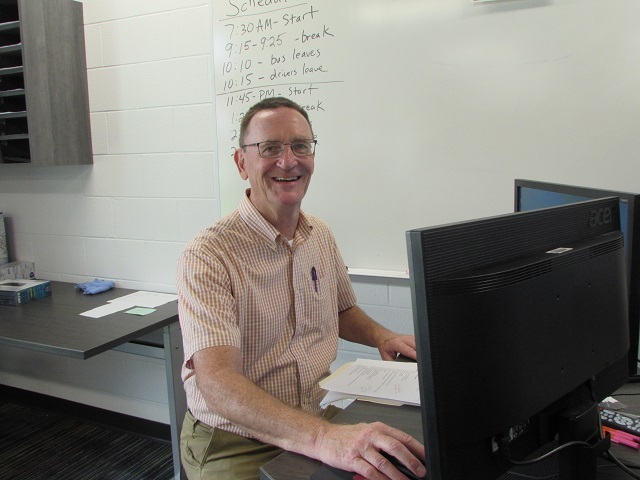 Cybersecurity instructor Mike Eilerman speaking to a group of eighth graders in his cybersecurity classroom.: Featured Image 1 