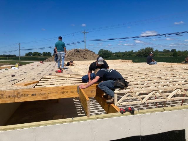 Seniors work on the subfloor of the 2024 Tri Star house.: Featured Image 1 
