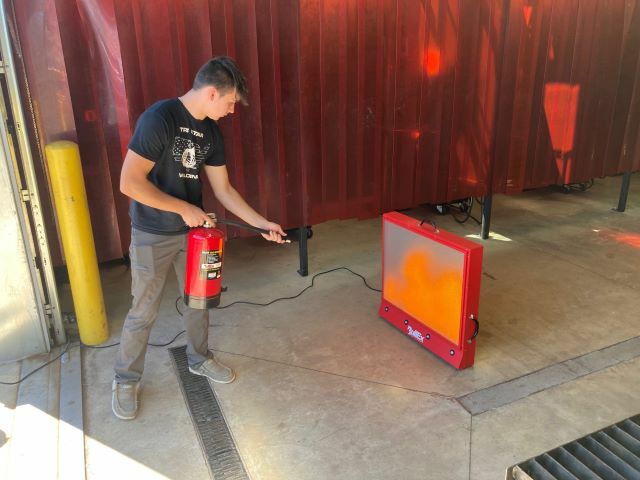 A welding student uses the simulator to get the feel for using a fire extinguisher.: Featured Image 1 