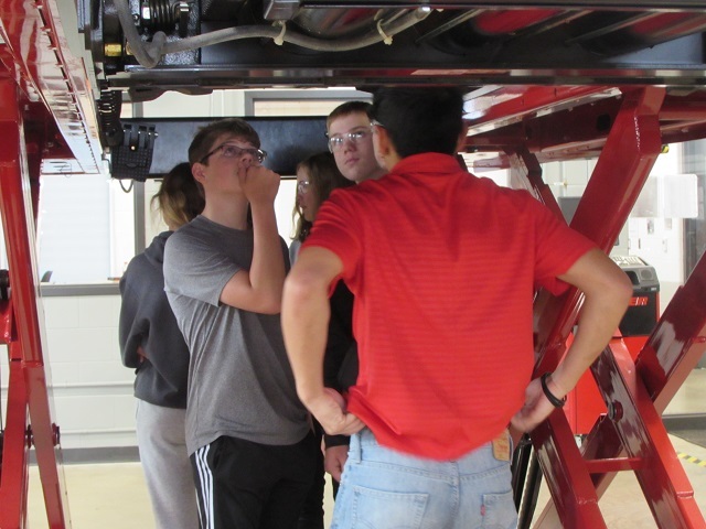 Minster students take a look under a vehicle lift in the automotive technology lab.: Featured Image 1 