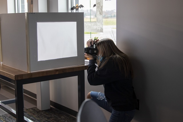 Olivia using a light box to photograph a product.: Featured Image 1 
