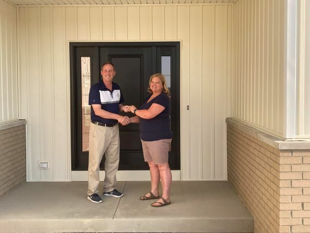 Tim Buschur is pictured handing over the keys to Pam Rasawehr.: Featured Image 1 
