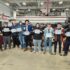 Senior Auto Tech students pose with their ASE certificates in the auto tech lab. 