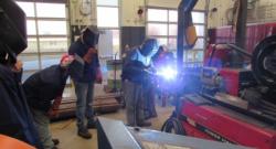 Adult students learning in the welding class. 